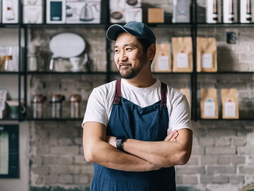 Middle-aged business owner standing in his coffee shop.